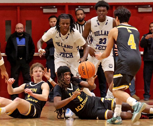 Latin Academy's Krem Amparo looks for the pass to Joaquim Lombos as Holland Tech's Ian Piper moves in during the second half of a boys Boston City League championship basketball game at Madison Park High. (Photo By Matt Stone/Boston Herald)