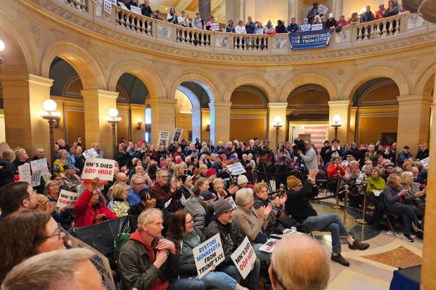 Hundreds of people attend a rally in the rotunda of the Minnesota State Capitol.