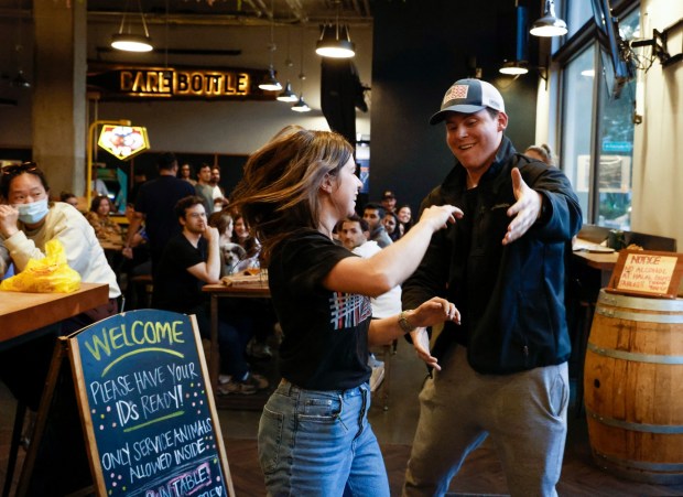 Joanna Ringhofer, of Santa Clara, and Drew Maxwell, of San Mateo, participate in a dance battle during trivia night at Barebottle Brewing Santa Clara in Santa Clara, Calif., on Tuesday, May 23, 2023. (Shae Hammond/Bay Area News Group)