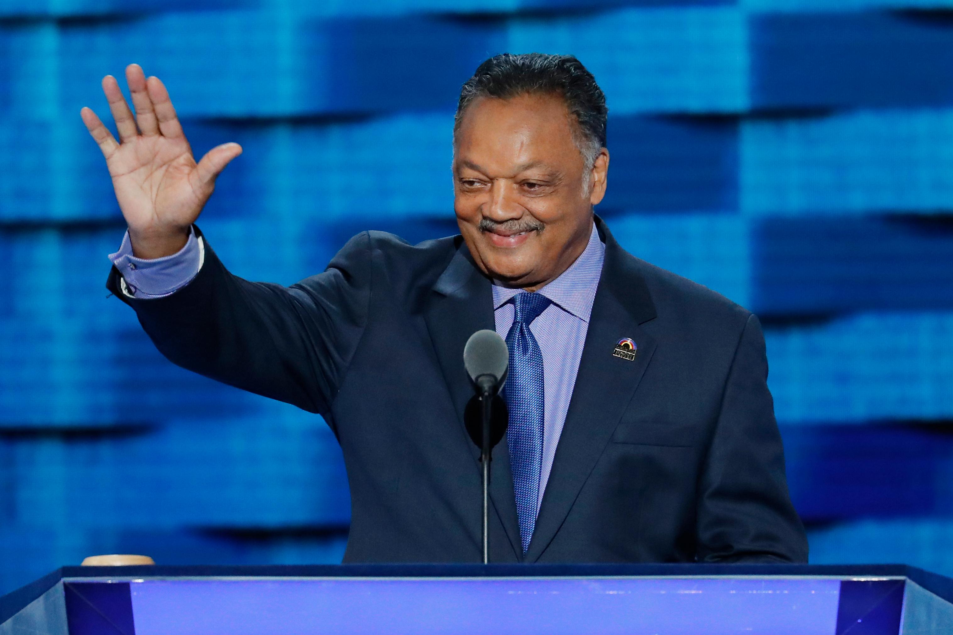 FILE – Rev. Jesse Jackson waves as he steps to...
