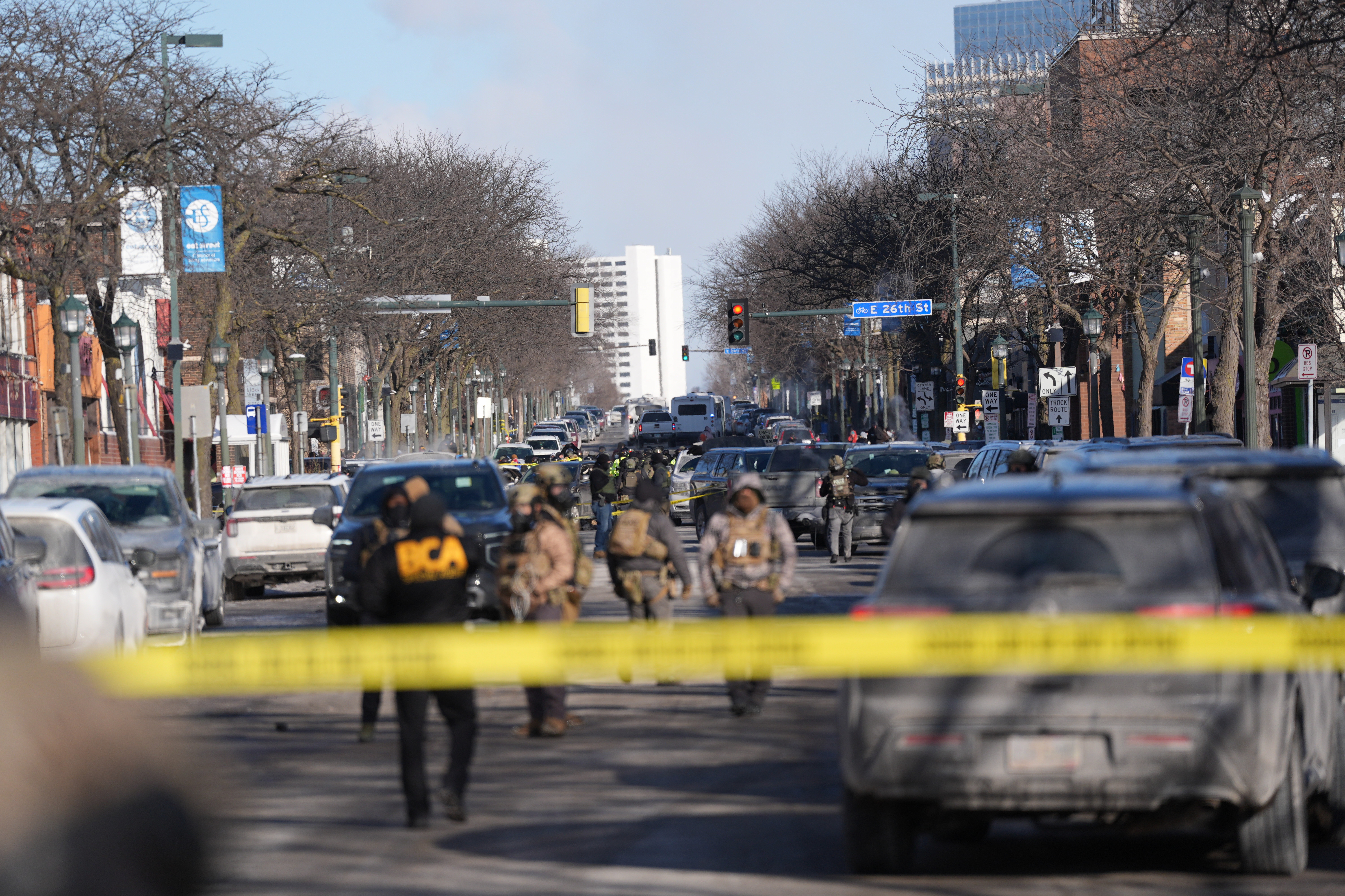 Federal agents stand near the site of a shooting