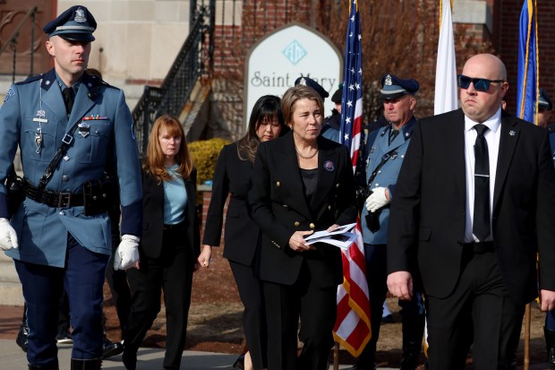 Gov. Maura Healey exits St. Mary's Church, Thursday, in Franklin after the funeral service for fallen Uxbridge police officer Stephen LaPorta. (Mark Stockwell/Boston Herald)