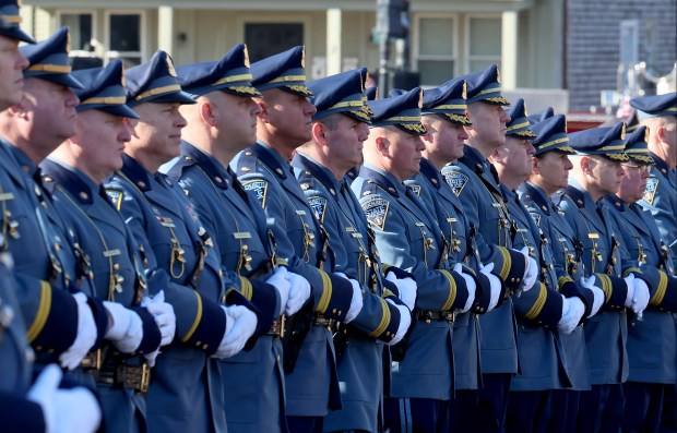 Massachusetts state troopers stand outside of St. Mary's Church, Thursday, in Franklin during the funeral service for fallen Uxbridge police officer Stephen LaPorta. LaPorta died after getting hit by a tractor-trailer on Jan. 7 while assisting a motorist. (Mark Stockwell/Boston Herald)