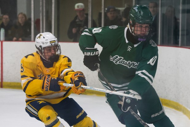 Marshfield's Brendan Kiziuk and Xaverian's Lochlan Horsman battle on the ice during Sunday's Div. 1 boys hockey game. (Photo by Reba Saldanha/Boston Herald)