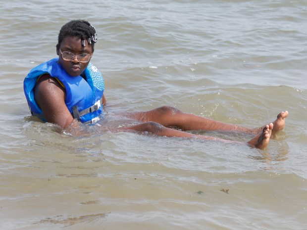 Rica Clouden, 10, of Boston, cools off in the water off Carson Beach during Caribbean Carnival Kickoff festivities Saturday. (Photo by Paul Connors/Media News Group/Boston Herald)