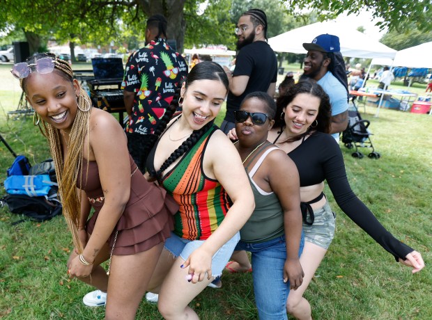 Dancers, from left, Kiahna Felix, D.J. Starla, Tanya Dubuisson, and Jeyana Neto, all of Boston, dance to soca music during Caribbean Carnival Kickoff festivities at South Boston's Carson Beach on Saturday. (Photo by Paul Connors/Media News Group/Boston Herald)
