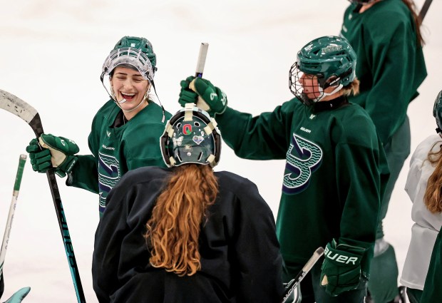 Boston Fleet's Megan Keller, left, laughs with teammates at the end of a recent practice at the Boston Sports Institute in Wellesley. (Mark Stockwell/Boston Herald)