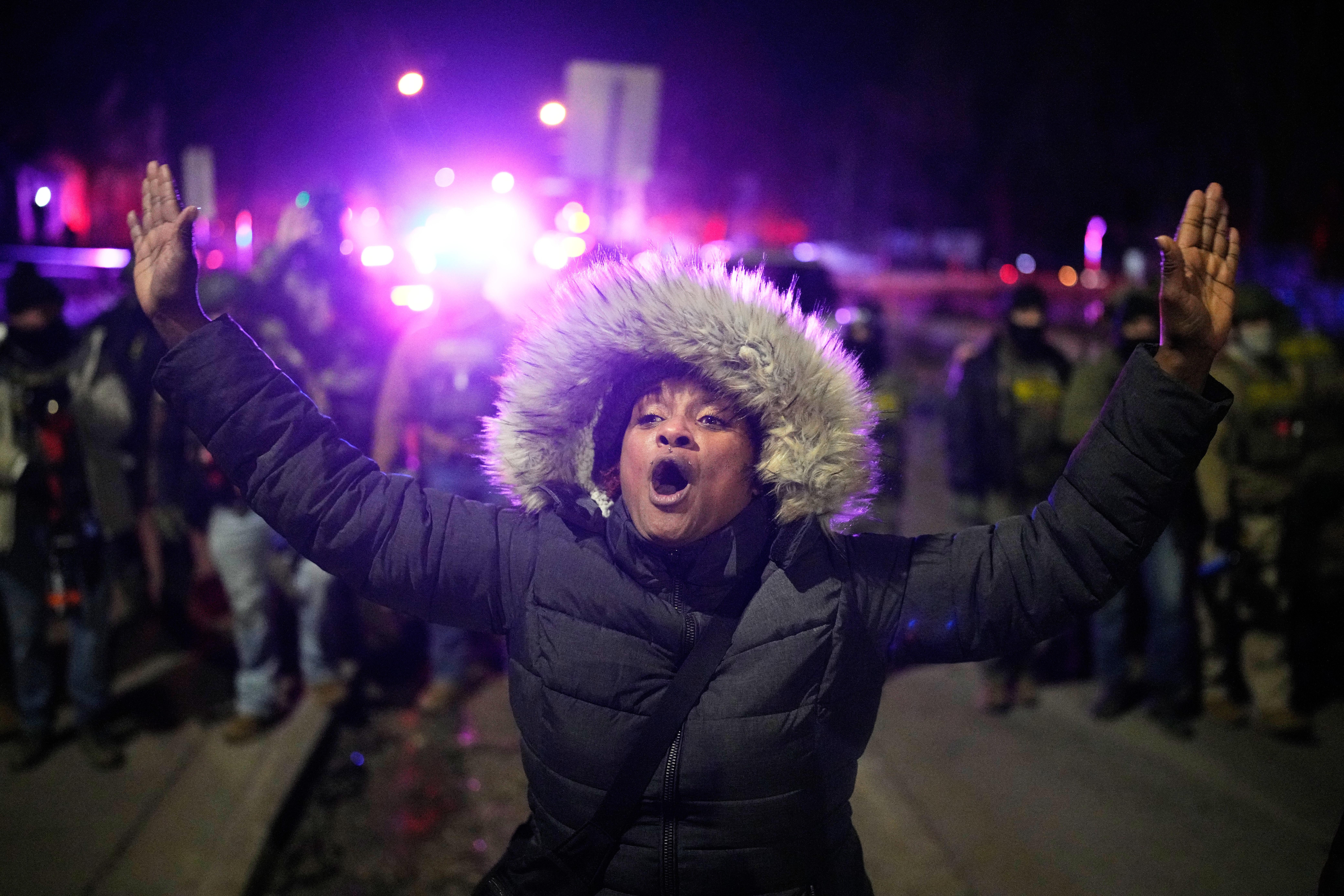 A protester yells in front of law enforcement after a...