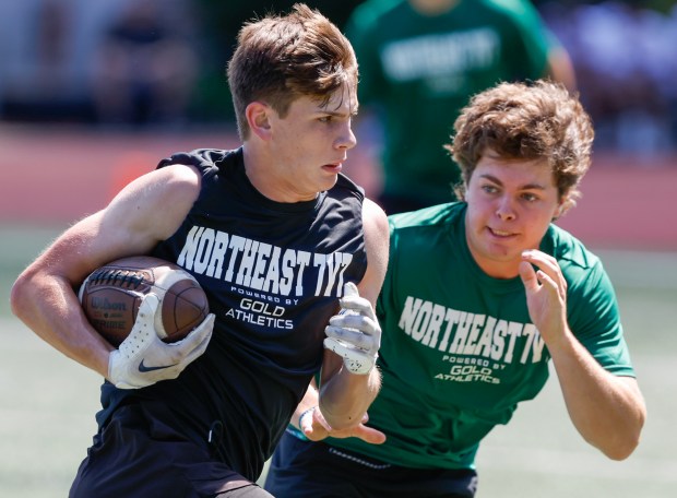 Plymouth South's Rob Anzalone, left, is pursued by Marshfield's Tim Stiles after making a reception during their Northeast 7-on-7 football game. (Photo by Paul Connors/Media News Group/Boston Herald)