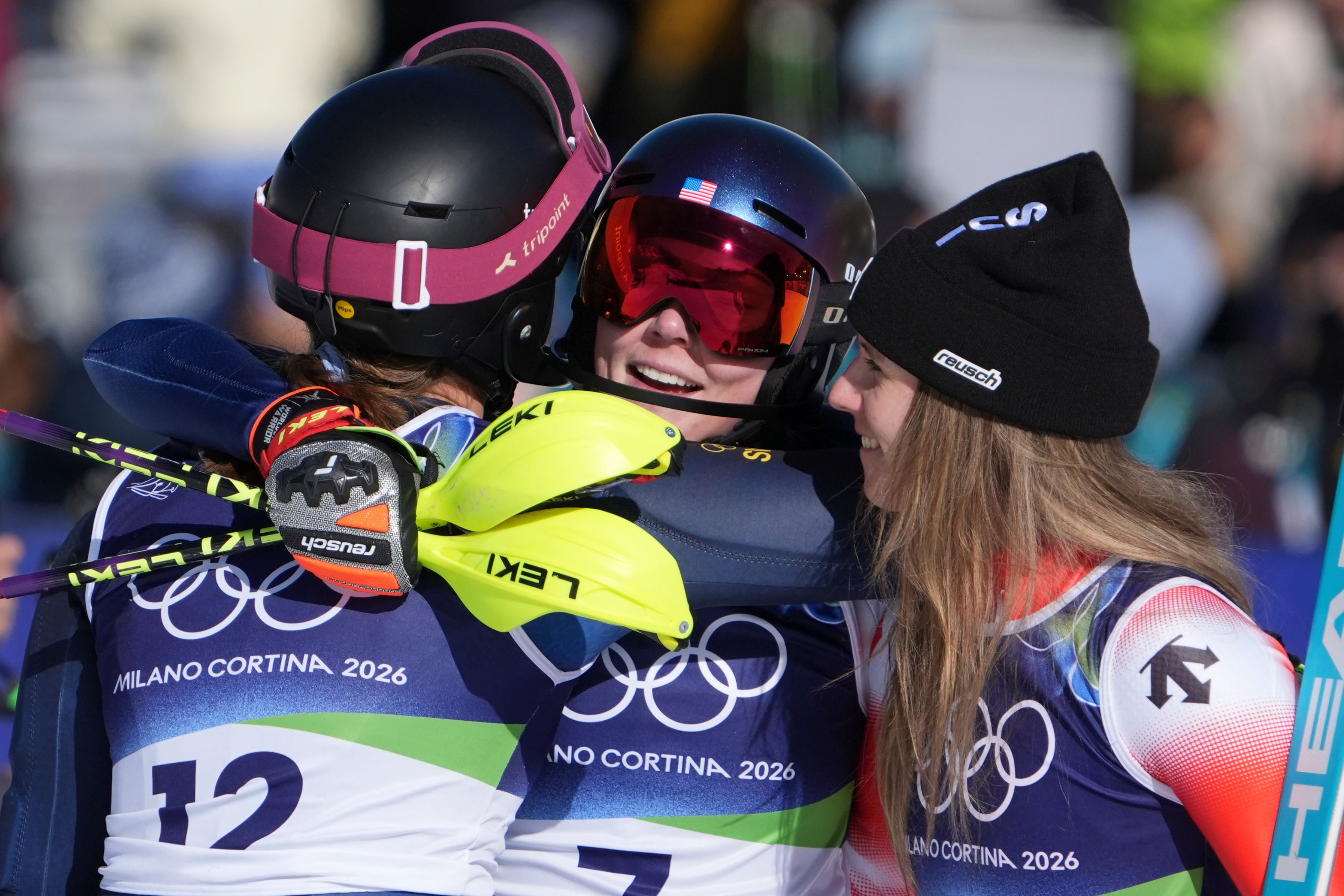 Mikaela Shiffrin celebrates with second-placed Camille Rast and third-placed Anna Swenn Larsson.