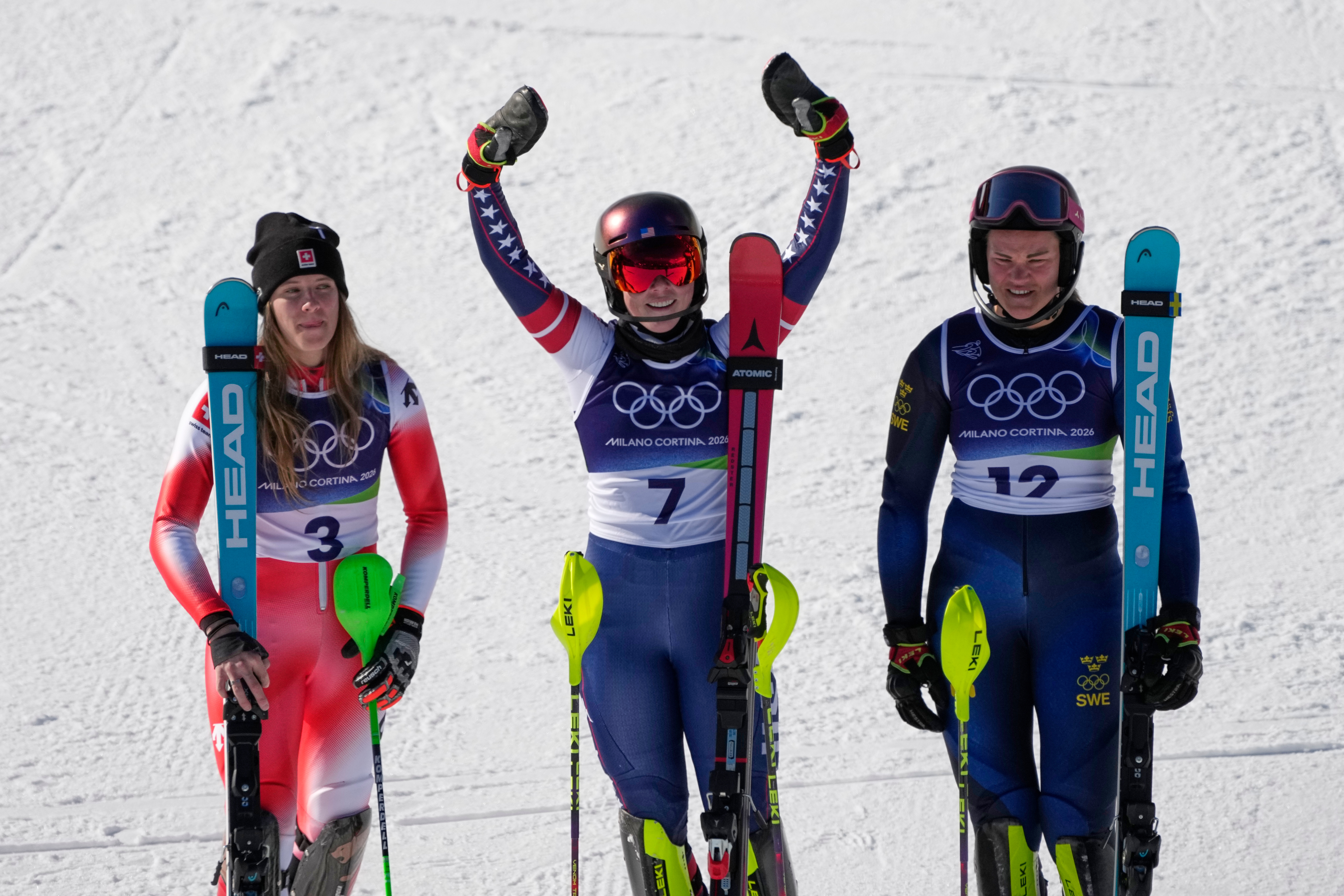 Mikaela Shiffrin celebrates with second-placed Camille Rast and third-placed Anna Swenn Larsson.