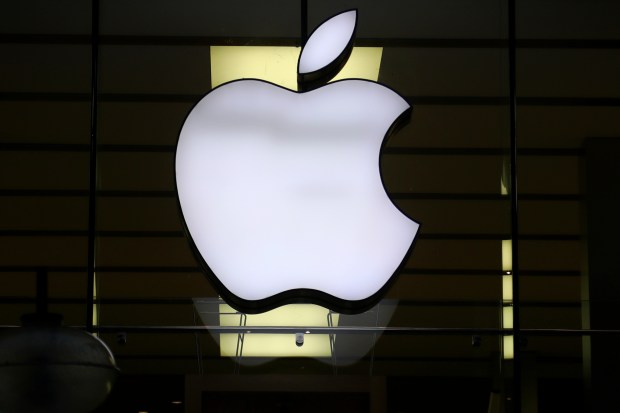 The Apple logo is illuminated at a store in Munich, Germany. (AP Photo/Matthias Schrader, File)