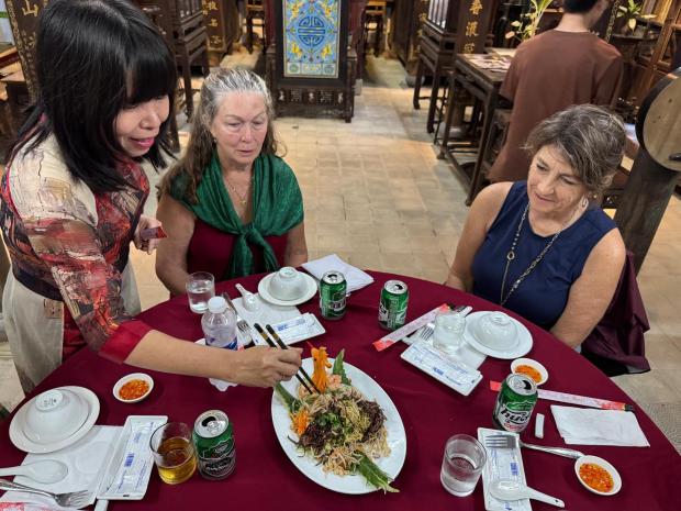 Dr. Phan Thuan Thao serves a Vietnamese vegetable and noodle dish her mother helped cook in their home in Hue. (Lori Rackl/Lori Rackl/TNS)