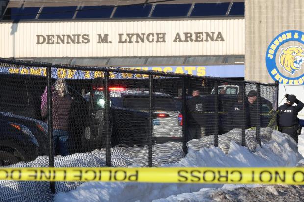 Police and ATF agents stand near the Lynch Arena in Pawtucket, R.I., after a shooting at the ice rink, Monday, Feb. 16, 2026. (AP Photo/Mark Stockwell)