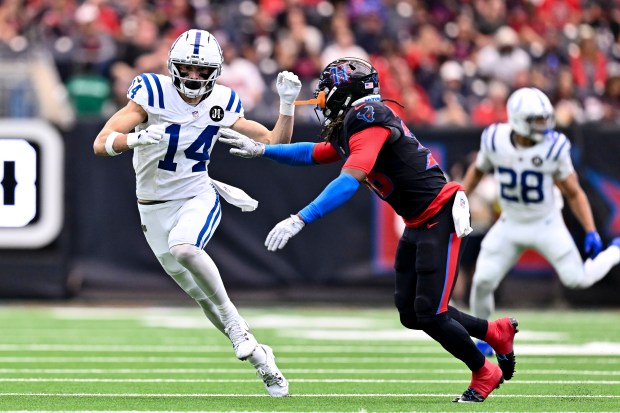 Indianapolis Colts wide receiver Alec Pierce (14) runs a route as Houston Texans safety K'Von Wallace (38) defends during an NFL football game Sunday, Jan. 4, 2026, in Houston. (AP Photo/Maria Lysaker)