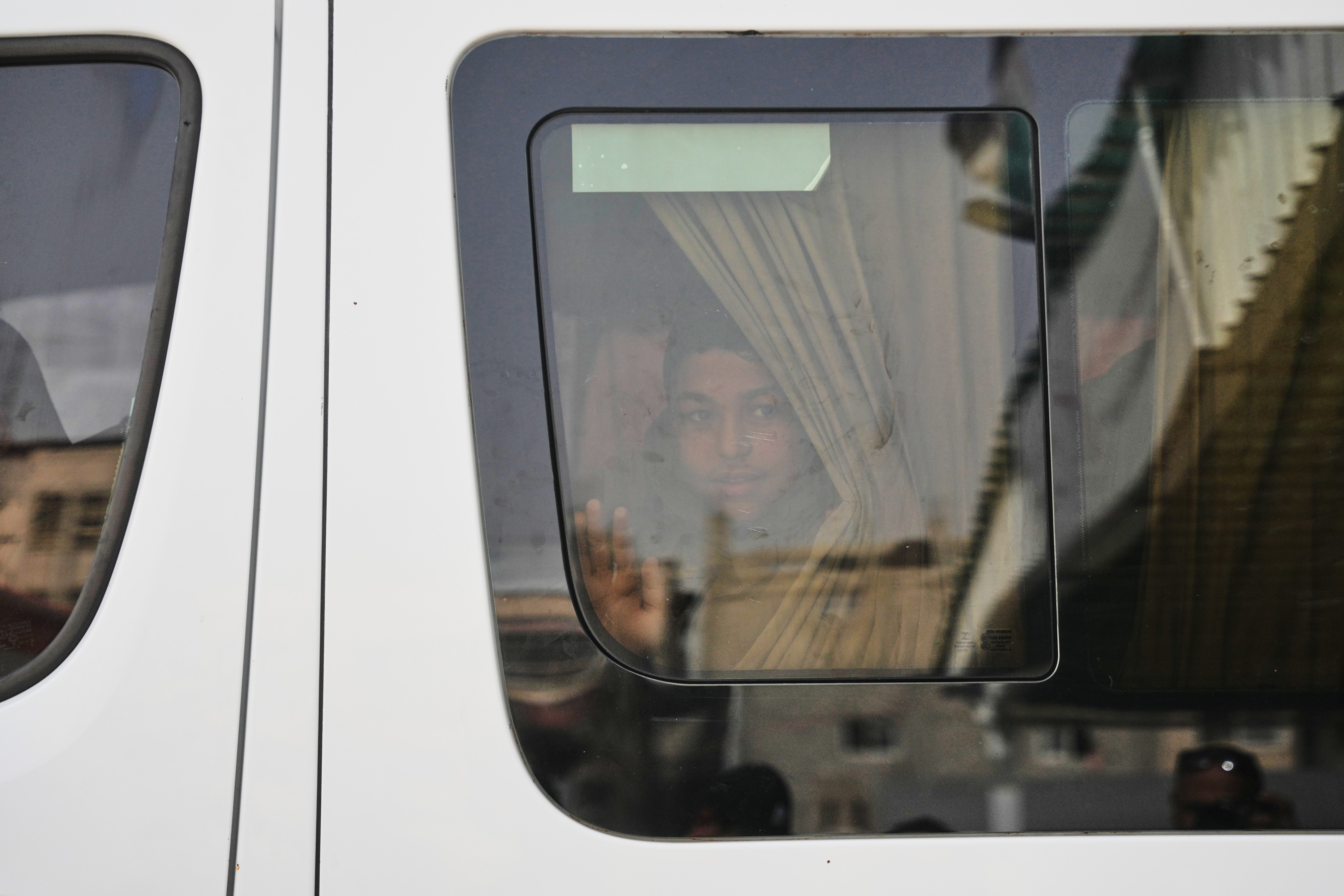 Palestinian patients wave from a vehicle in Khan Younis on...