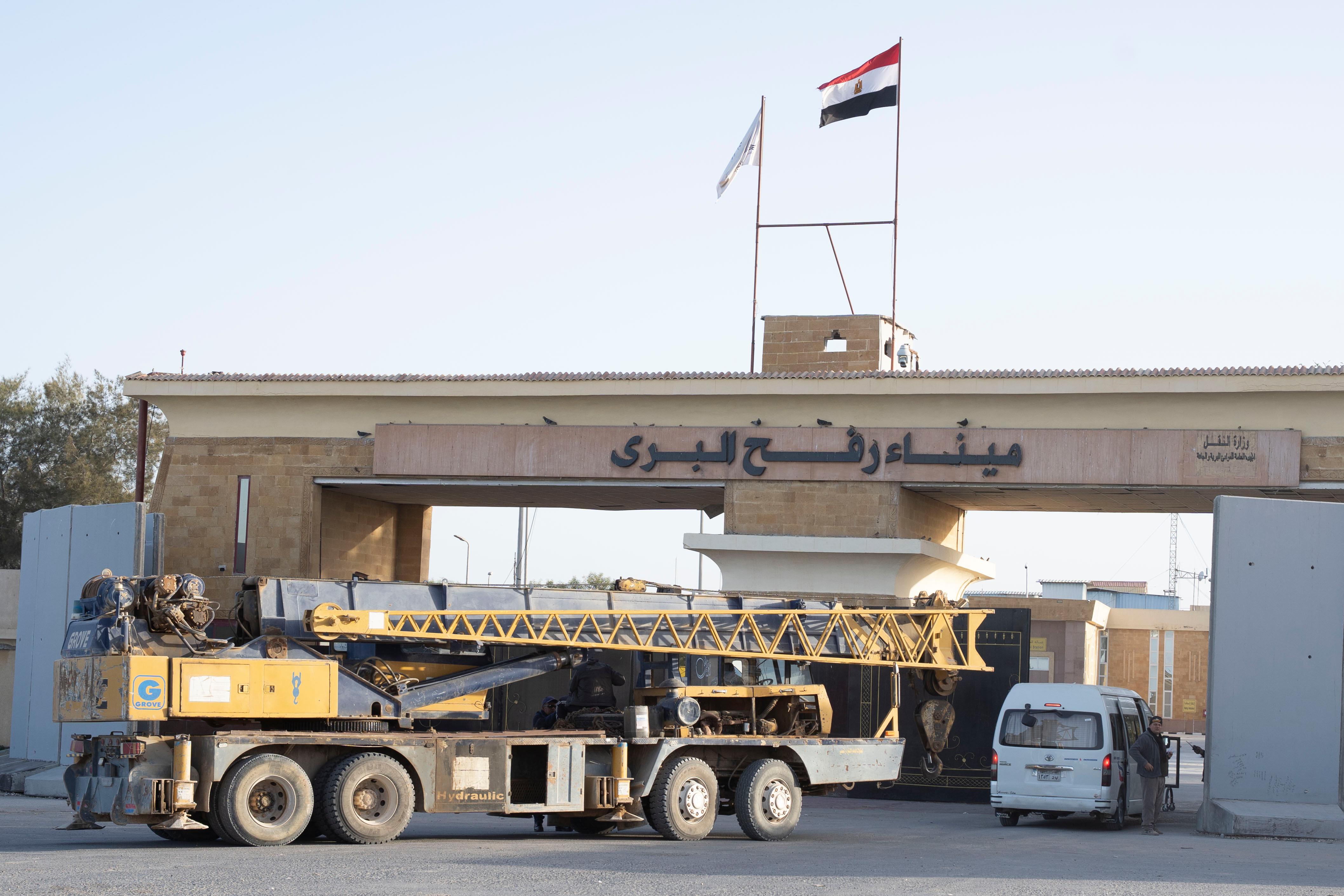 A crane enters the Egyptian gate of the Rafah crossing...