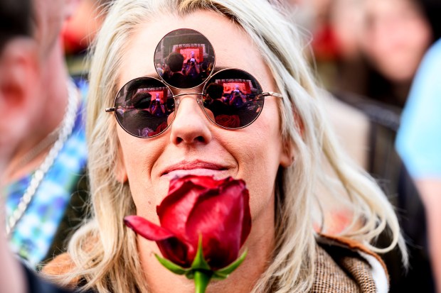 Sarah Black holds a rose while attending a public memorial for Grateful Dead guitarist Bob Weir in San Francisco. (AP Photo/Noah Berger)