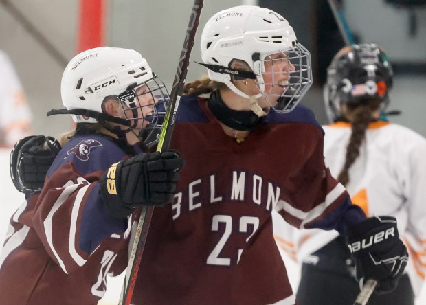 Belmont's Mackenzie Tierney, left, and teammate Elise Lakin-Schultz celebrate after scoring a goal against Woburn during the first period of a hockey game Saturday, February 7, 2026, in Woburn, Massachusetts. (Photo by Paul Connors/Media News Group/Boston Herald)