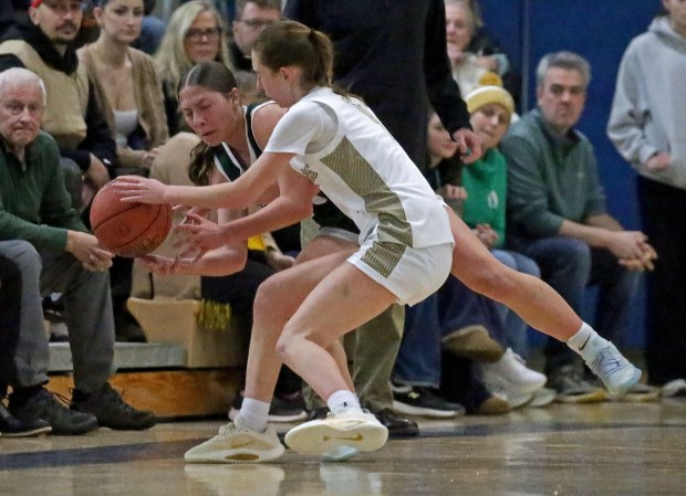 Pentucket's Sofia Bellacqua, left, and Bishop Fenwick's Abby Jenkins wrestle for the ball during Feehan's 39-23 win. (Staff photo by Stuart Cahill)