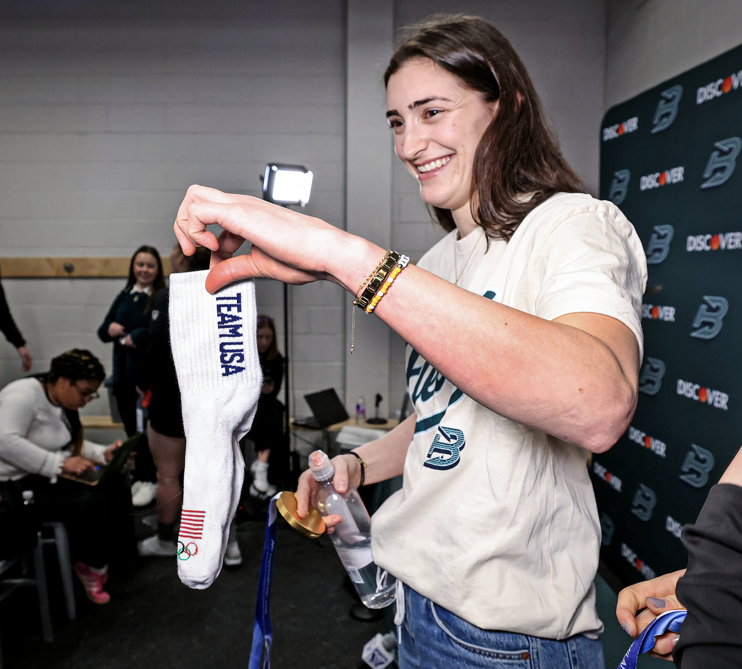 Megan Keller holds up a Team USA sock that she...