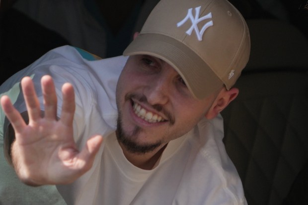 Freed Israeli hostage Eitan Mor gestures from a van as he arrives at Beilinson hospital in Petah Tikva, Israel, after he was released from Hamas captivity in the Gaza Strip on Monday. (AP Photo/Ariel Schalit)