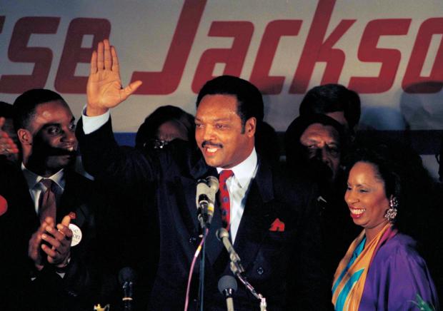 FILE - Jesse Jackson, with his wife Jacqueline, concedes defeat in the Illinois Democratic primary on March 16, 1988, in Chicago. (AP Photo/Lisa Genesen, File)