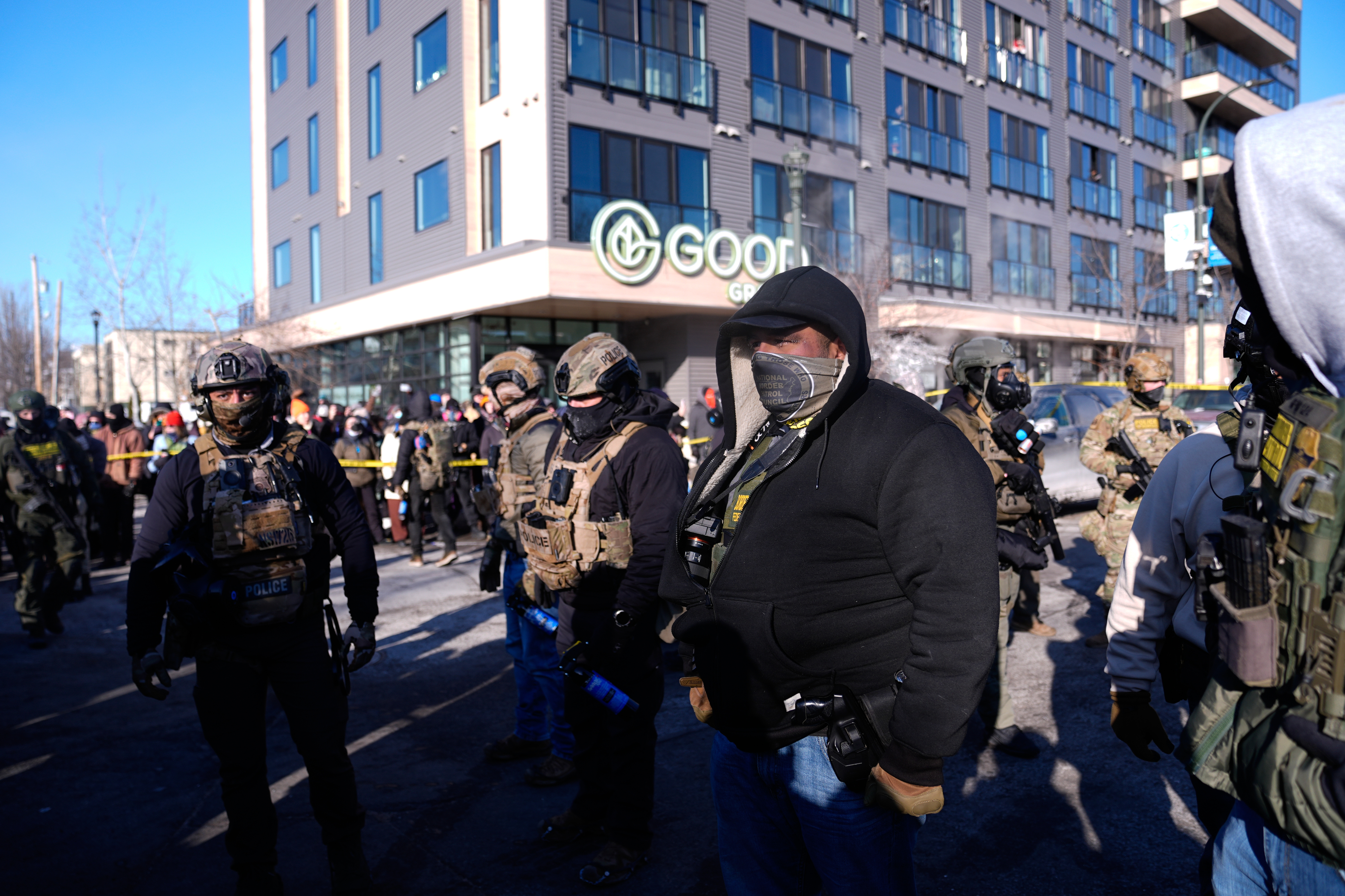 Federal agents stand near the site of a shooting