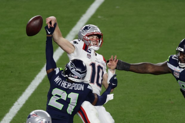 Seattle Seahawks cornerback Devon Witherspoon (21) forces a fumble against New England Patriots quarterback Drake Maye during the Super Bowl. (Adam Hunger/AP Content Services for the NFL)