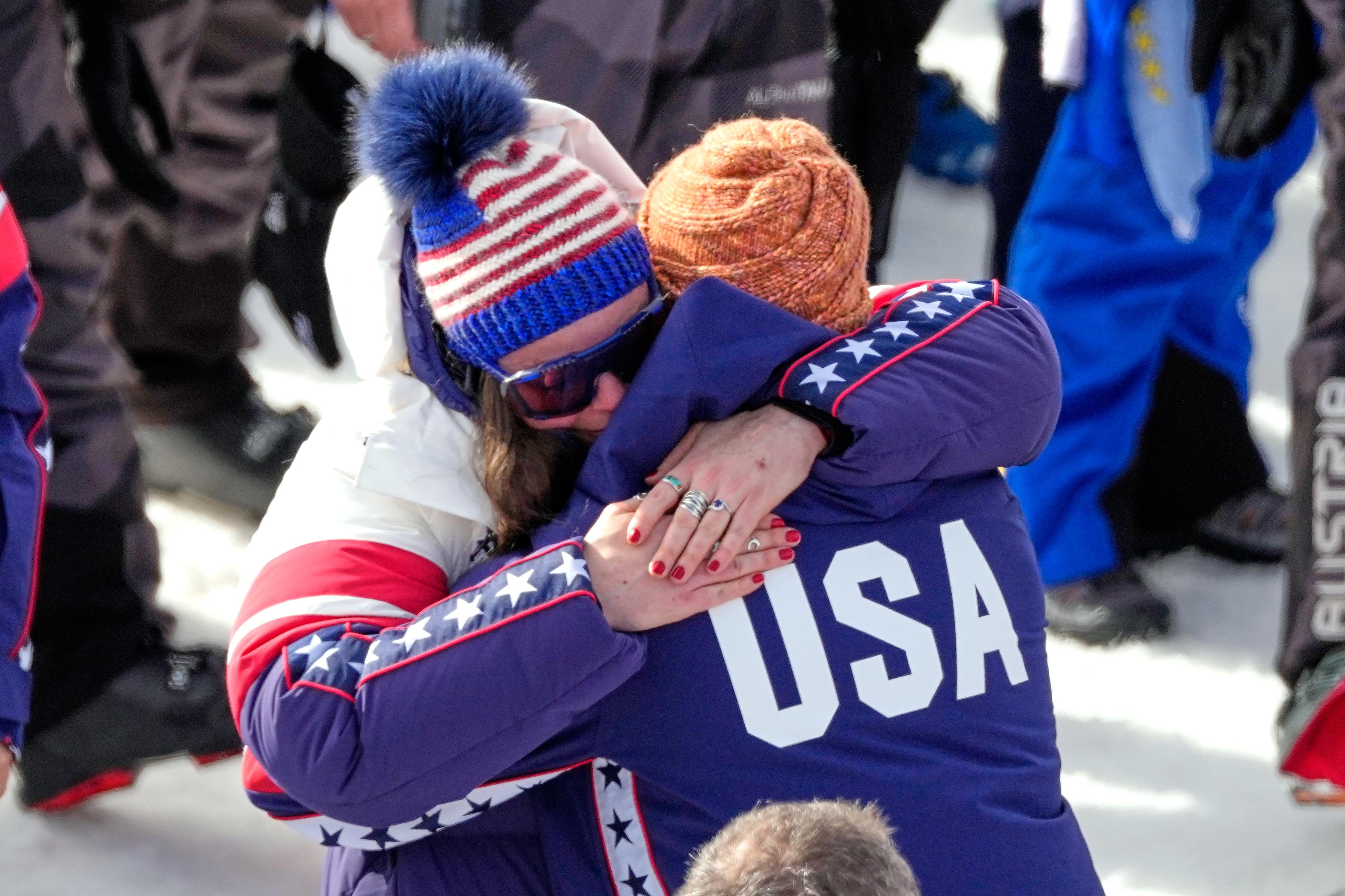 United States’ Breezy Johnson hugs Connor Watkins, at the finish...