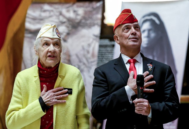 Gold Star mother Jeanette Rose, left, and Gold Star father, state Rep. Steven Xiarhos, right, lead the Pledge of Allegiance during Iwo Jima Day in Memorial Hall at the State House, Thursday. The battle of Iwo Jima began on Feb. 19, 1945. (Mark Stockwell/Boston Herald)