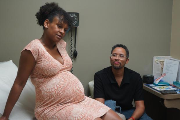 JaKobi Burton looks at his pregnant wife, Crystal Wilmot-Burton, during a prenatal appointment in Indianapolis.
