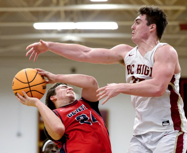 BC High's Liam Lee, right, fouls Central Catholic's Drew O'Keefe (24) during the second half of a boys basketball game, Sunday, in Boston. (Mark Stockwell/Boston Herald)