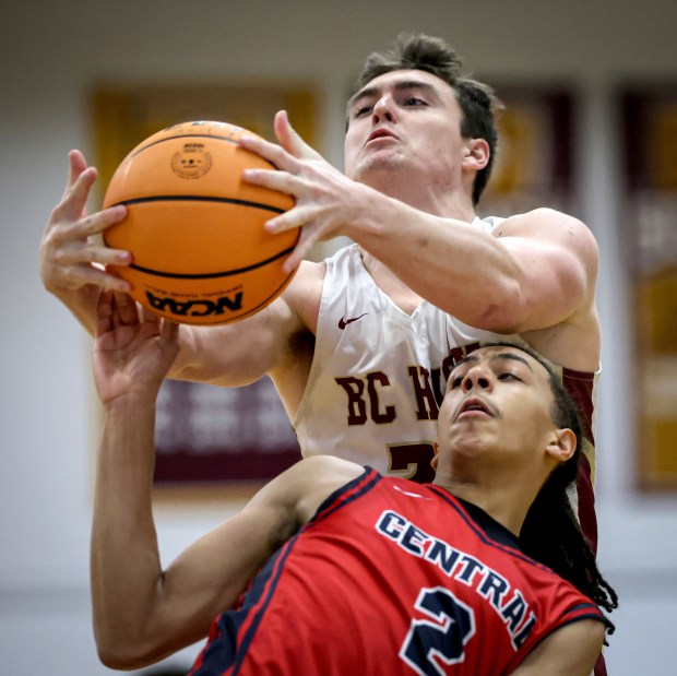 Central Catholic's Nizeah Castillo (2) attempts to block a layup by BC High's Liam Lee (35) during a boys basketball game, Sunday, in Boston. (Mark Stockwell/Boston Herald)