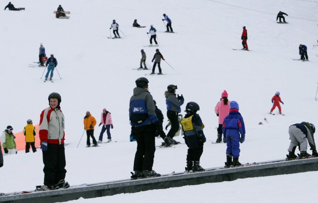 Beginner skiers ride an escalator at Attitash Ski area in Bartlett, N.H. (AP File Photo/Jim Cole)