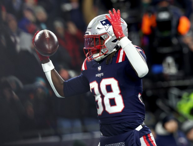 New England Patriots running back Rhamondre Stevenson celebrates his touchdown during the first quarter of Sunday's game at Gillette Stadium. (Nancy Lane/Boston Herald)