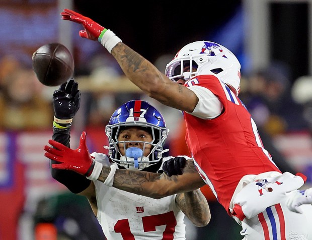 Christian Gonzalez of the New England Patriots swipes the ball away from New York Giants wide receiver Wan'Dale Robinson (17) during the second half of a NFL game at Gillette Stadium earlier this season. (Photo By Matt Stone/Boston Herald)