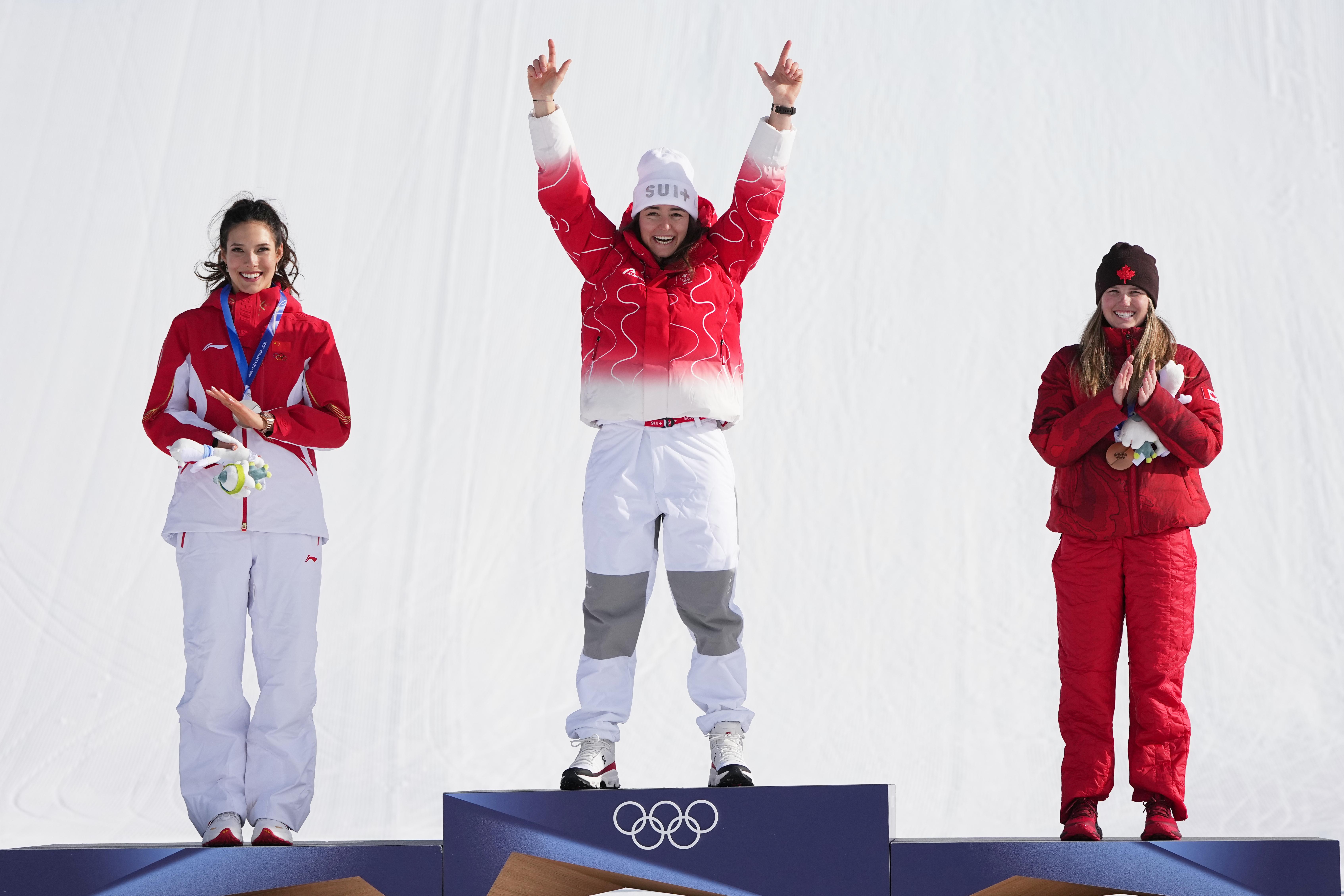 Gold medalist Switzerland’s Mathilde Gremaud, center, celebrates alongside silver medalist...