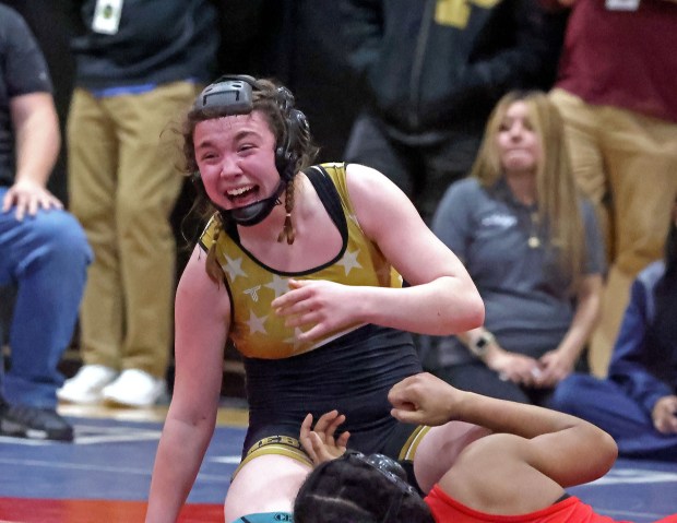 Cassidy Robertson of Northeast Metro Tech/Bishop Fenwick celebrates the win at 152 pounds at the Div. 2 wrestling championships. (Staff photo by Stuart Cahill)