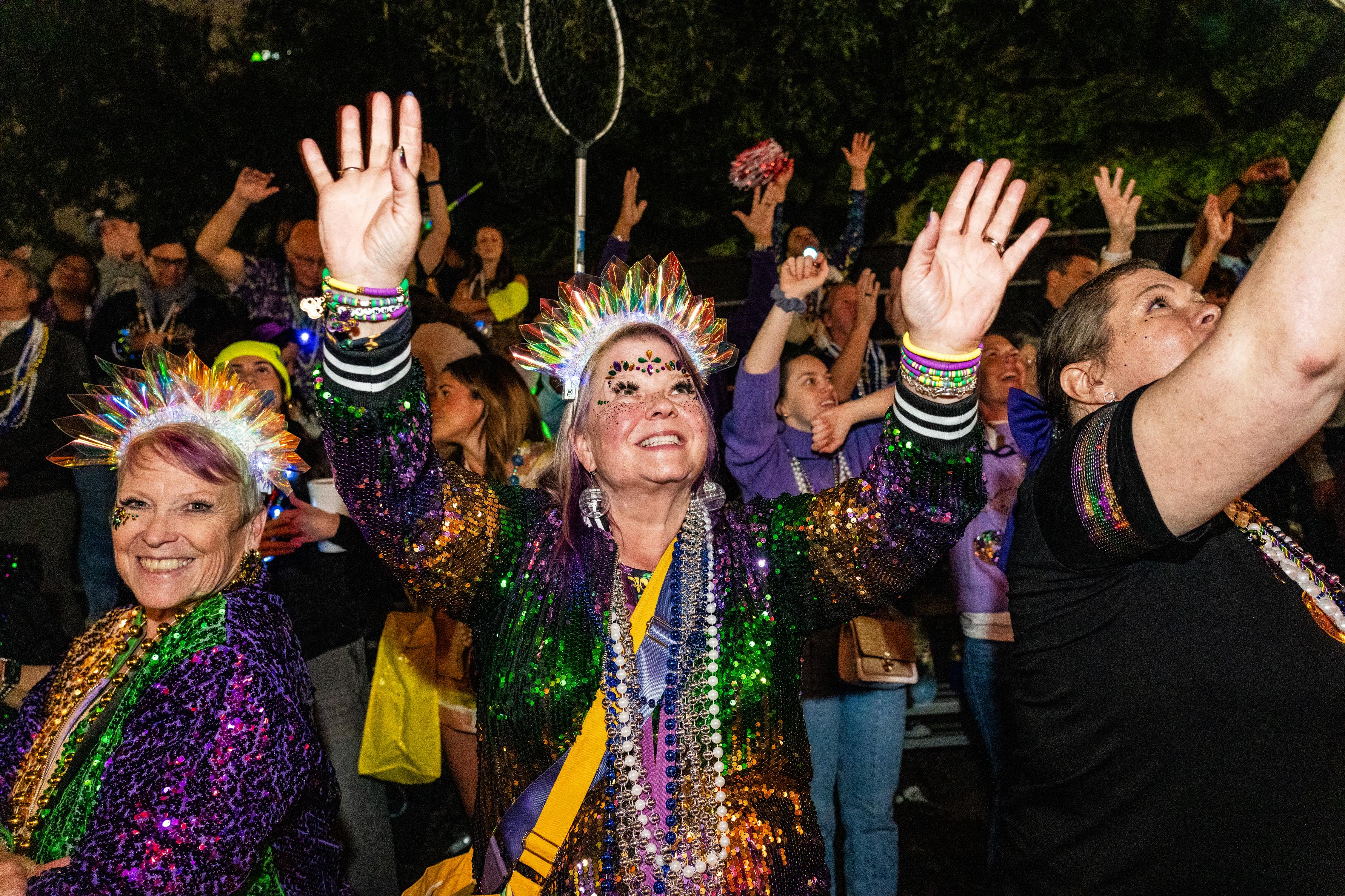 Attendees participate in the annual Krewe of Muses parade during...