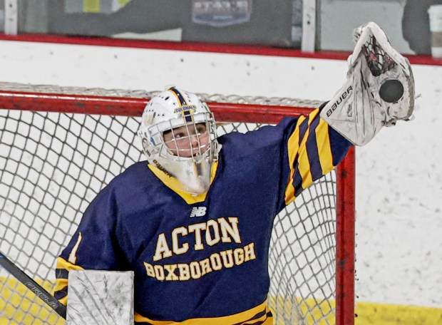 Acton-Boxboro goalie Gigi Welch makes a glove save during a girls hockey game against Arlington Catholic on Wednesday in Arlington. (Mark Stockwell/Boston Herald)