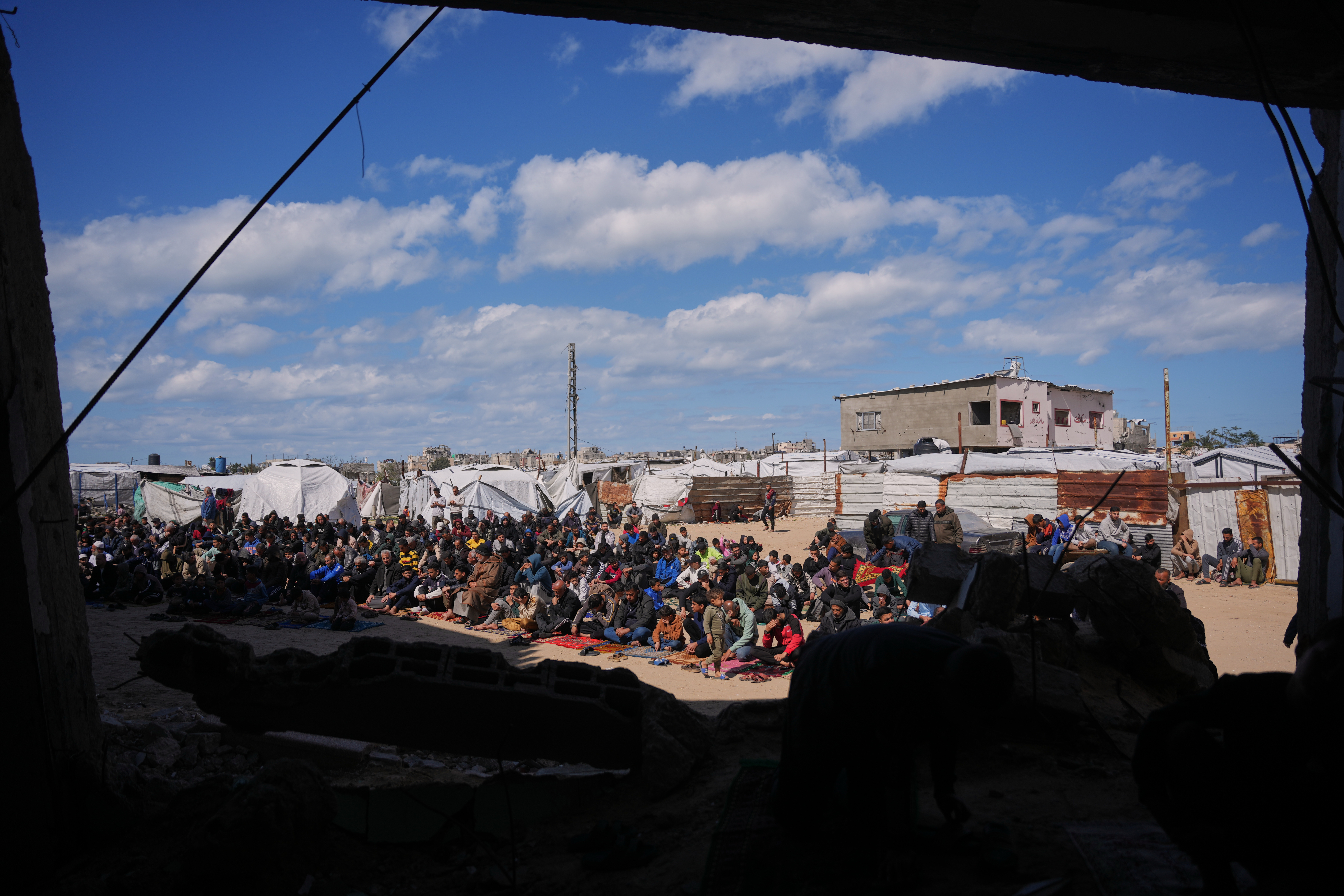 Muslim worshippers perform Friday prayers during the holy month of Ramadan outside the destroyed Al-Albani Mosque.