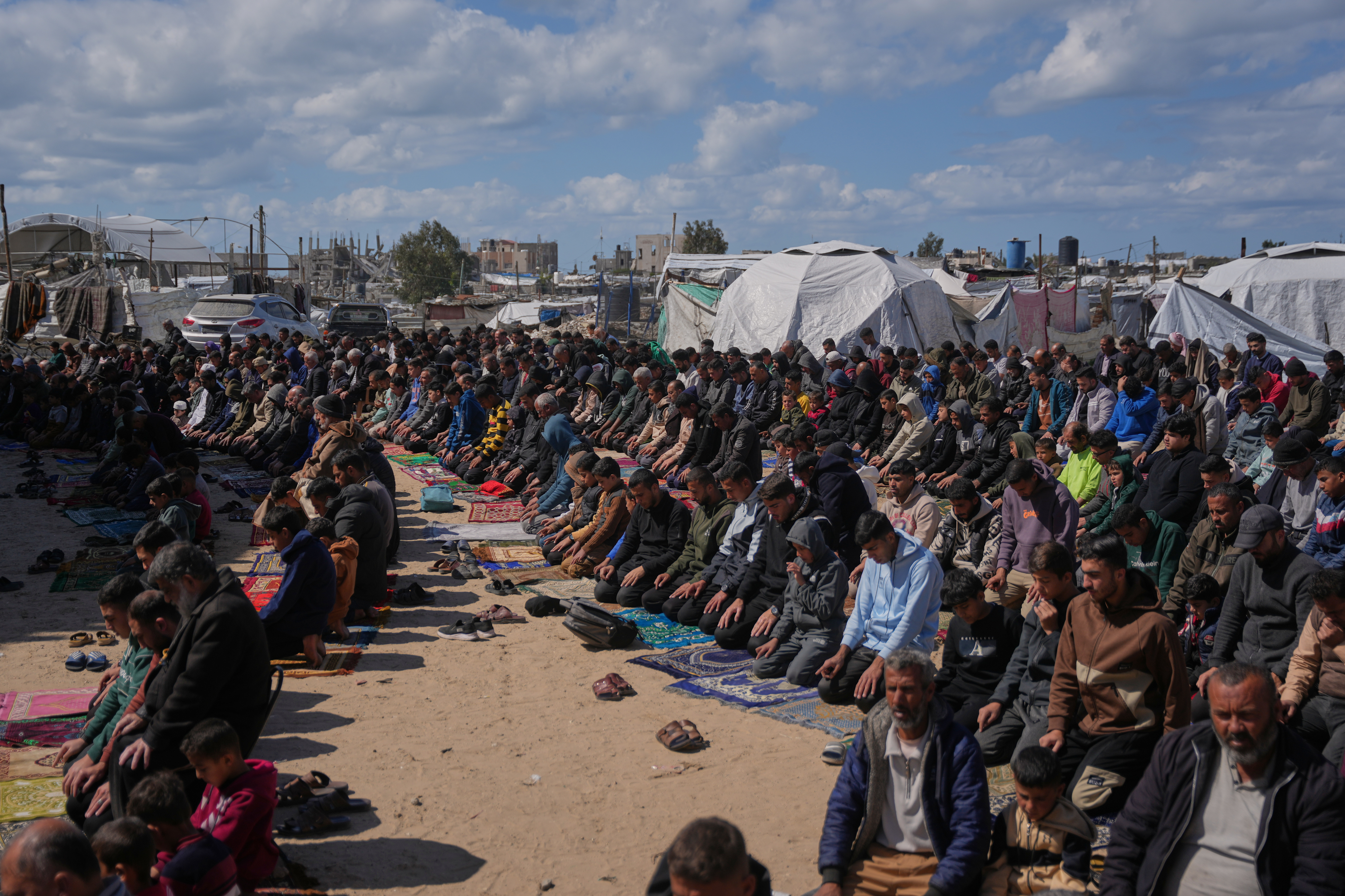 Muslim worshippers perform Friday prayers during the holy month of Ramadan outside the destroyed Al-Albani Mosque.