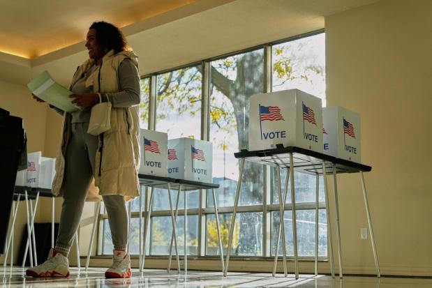 FILE - People wait to cast their ballot at the Horatio Williams Foundation in downtown Detroit, Tuesday, Nov. 4, 2025. (AP Photo/Ryan Sun,File)