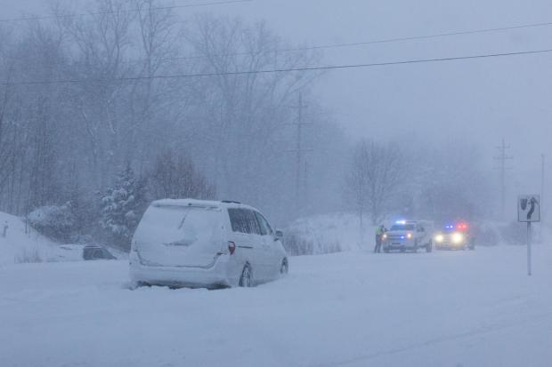 Multiple vehicles slid off the road in whiteout conditions along Lake Michigan Drive during a winter storm warning in Ottawa County, Mich. on Monday, Jan. 19, 2026. (Joel Bissell/Kalamazoo Gazette via AP)