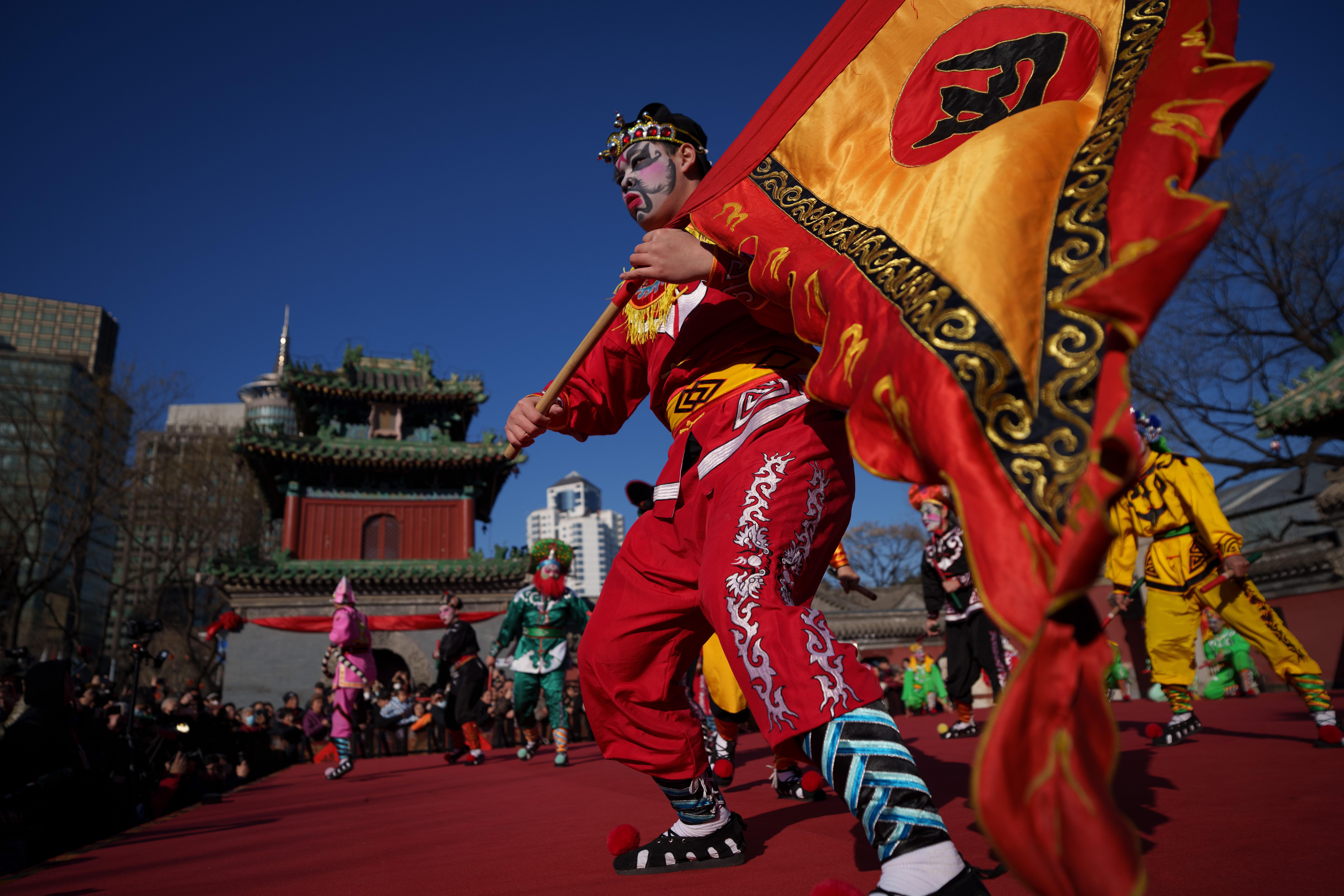 Dancers in colorful costumes perform Yingge Dance, a traditional folk...