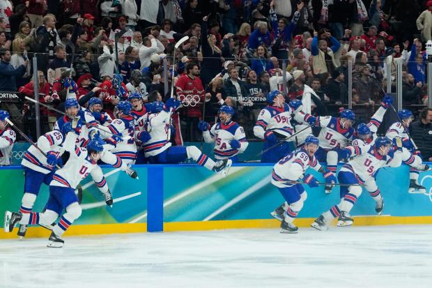 United States players celebrate after defeating Canada in a men's ice hockey gold medal game between Canada and the United States at the 2026 Winter Olympics, in Milan, Italy, Sunday, Feb. 22, 2026. (AP Photo/Petr David Josek)