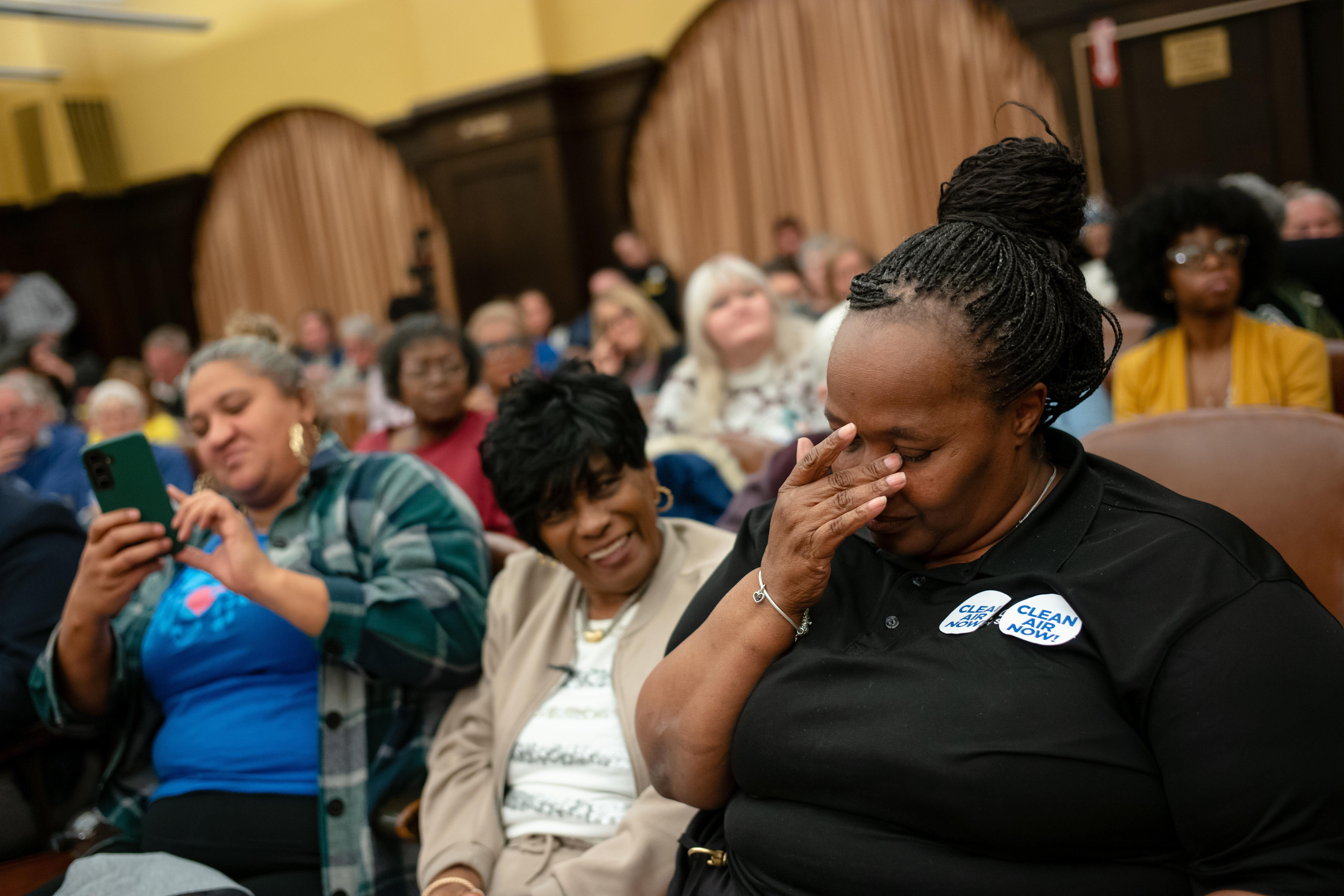 Carla Beard-Owens, right, and Jackie Wade, center, both of Clairton,...