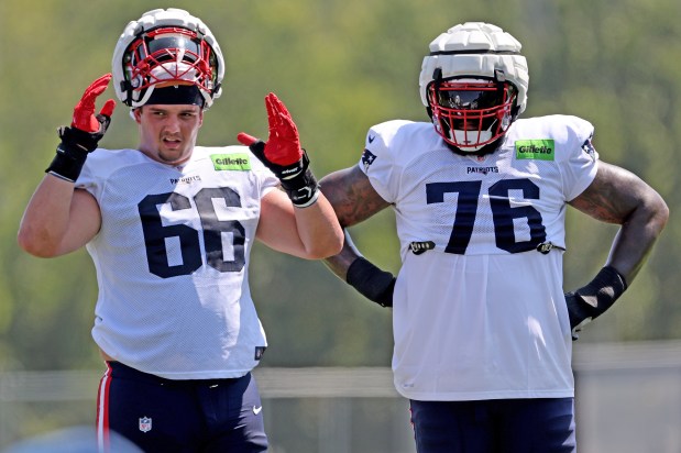 Offensive tackles Will Campbell (66) and Morgan Moses look on during a training camp practice. (Photo By Matt Stone/Boston Herald)