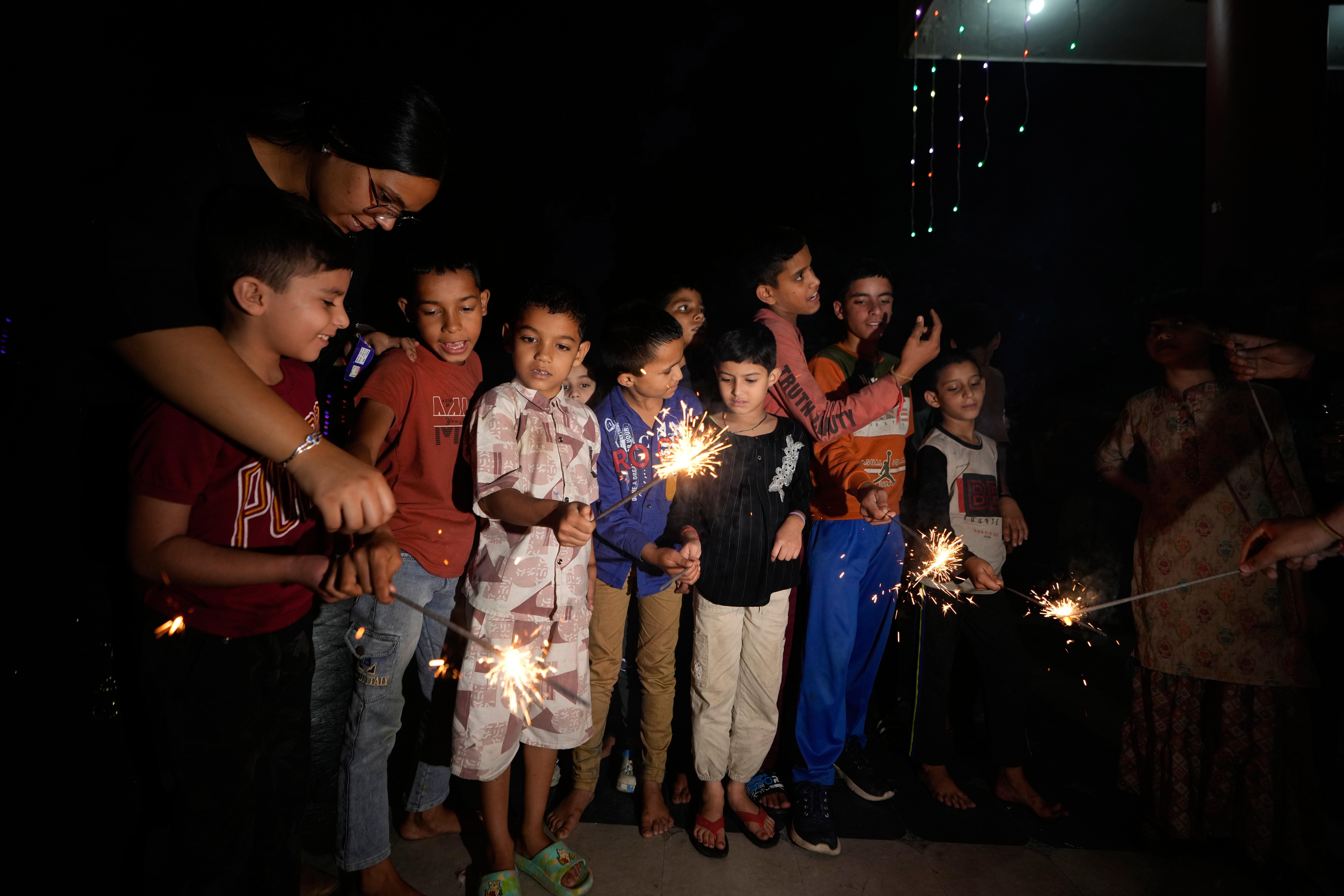 Children play with firecrackers on Diwali festival, the Hindu festival...